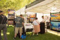 Art in the Park 2021 booth with paintings