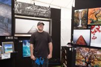 Art in the Park 2021 Mihael Ashley Luxury Fine Art artist standing with his work