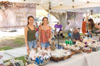 Art in the Park 2021 aravah organics vendors in booth with bath and beauty products